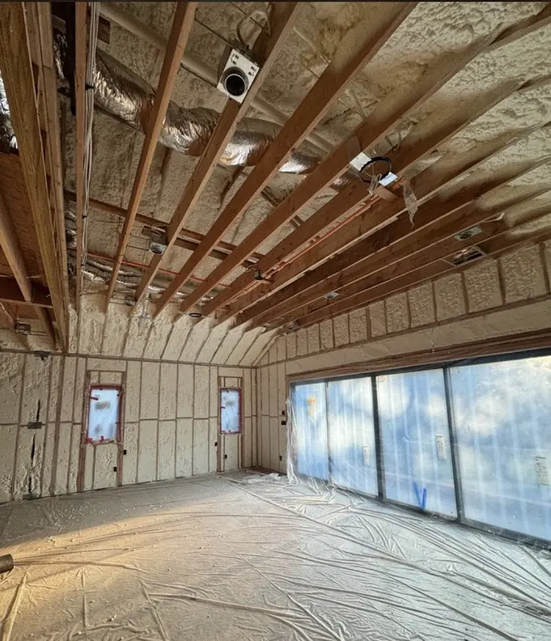 Interior walls and ceiling insulated with spray foam during new construction in Country Homes